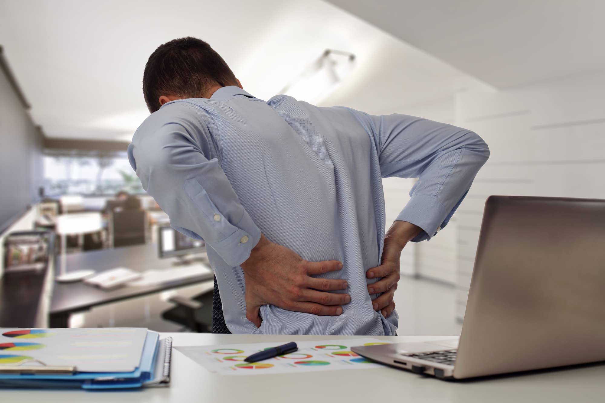 Business man with back pain. Pain relief concept.